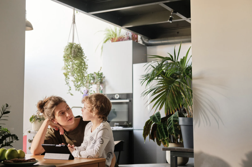 Mother sitting with her son at the kitchen table